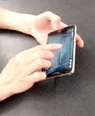 photo of hands and device of participant 8, group E, using the device.