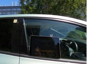 Photo of the outside car window with an embedded interactive voice device